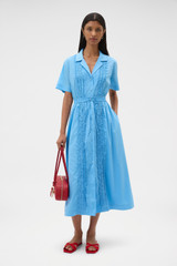Profile view of model wearing the Oroton Ruffle Detail Shirt Dress in Sea Blue and 100% cotton voile fabric for Women . IP:6