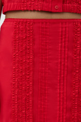 Profile view of model wearing the Oroton Ruffle Detail Skirt in Red Ribbon and 100% cotton voile fabric for Women . IP:4