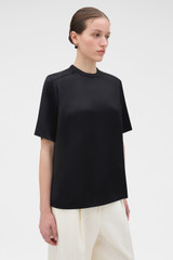 Profile view of model wearing the Oroton Double Satin Tee in Black and 100% viscose fabric for Women . IP:3