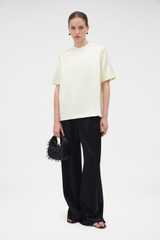 Profile view of model wearing the Oroton Double Satin Tee in Champagne and 100% viscose fabric for Women . IP:6
