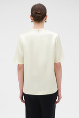 Profile view of model wearing the Oroton Double Satin Tee in Champagne and 100% viscose fabric for Women . IP:5