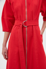 Profile view of model wearing the Oroton Zip Through Dress in Market Red and 100% cotton fabric for Women . IP:5