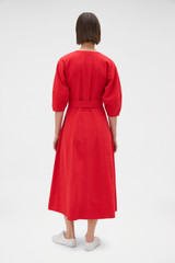 Profile view of model wearing the Oroton Zip Through Dress in Market Red and 100% cotton fabric for Women . IP:6