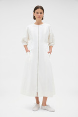 Profile view of model wearing the Oroton Zip Through Dress in Antique White and 100% cotton fabric for Women . IP:2