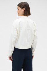 Profile view of model wearing the Oroton Curved Sleeve Jacket in Antique White and 100% cotton fabric for Women . IP:6