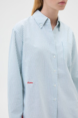 Profile view of model wearing the Oroton Oxford Stripe Shirt in Ivy Green and 100% cotton fabric for Women . IP:4