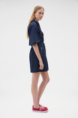 Profile view of model wearing the Oroton Washed Drill Dress in North Sea and 100% cotton fabric for Women . IP:3