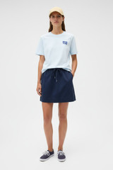 Profile view of model wearing the Oroton Maggie Graphic Tee in Pale Blue and 100% cotton single jersey fabric for Women . IP:7