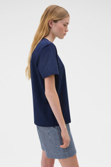 Profile view of model wearing the Oroton Maggie Graphic Tee in North Sea and 100% cotton single jersey fabric for Women . IP:3