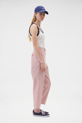 Profile view of model wearing the Oroton Curved Leg Railroad Pant in Robbin Red and 100% cotton fabric for Women . IP:3