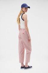 Profile view of model wearing the Oroton Curved Leg Railroad Pant in Robbin Red and 100% cotton fabric for Women . IP:5