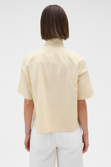 Profile view of model wearing the Oroton Pleat Detail Shirt in Wheat and 100% cotton fabric for Women . IP:5