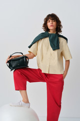 Profile view of model wearing the Oroton Pleat Detail Shirt in Wheat and 100% cotton fabric for Women . IP:8