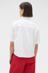 Profile view of model wearing the Oroton Pleat Detail Shirt in White and 100% cotton fabric for Women . IP:5