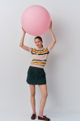 Profile view of model wearing the Oroton Pleated Mini in Neptune Green and 100% cotton poplin fabric for Women . IP:9