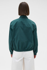 Profile view of model wearing the Oroton Pleated Bomber Shirt in Neptune Green and 100% cotton poplin fabric for Women . IP:5