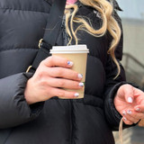compostable paper coffee cup in hand