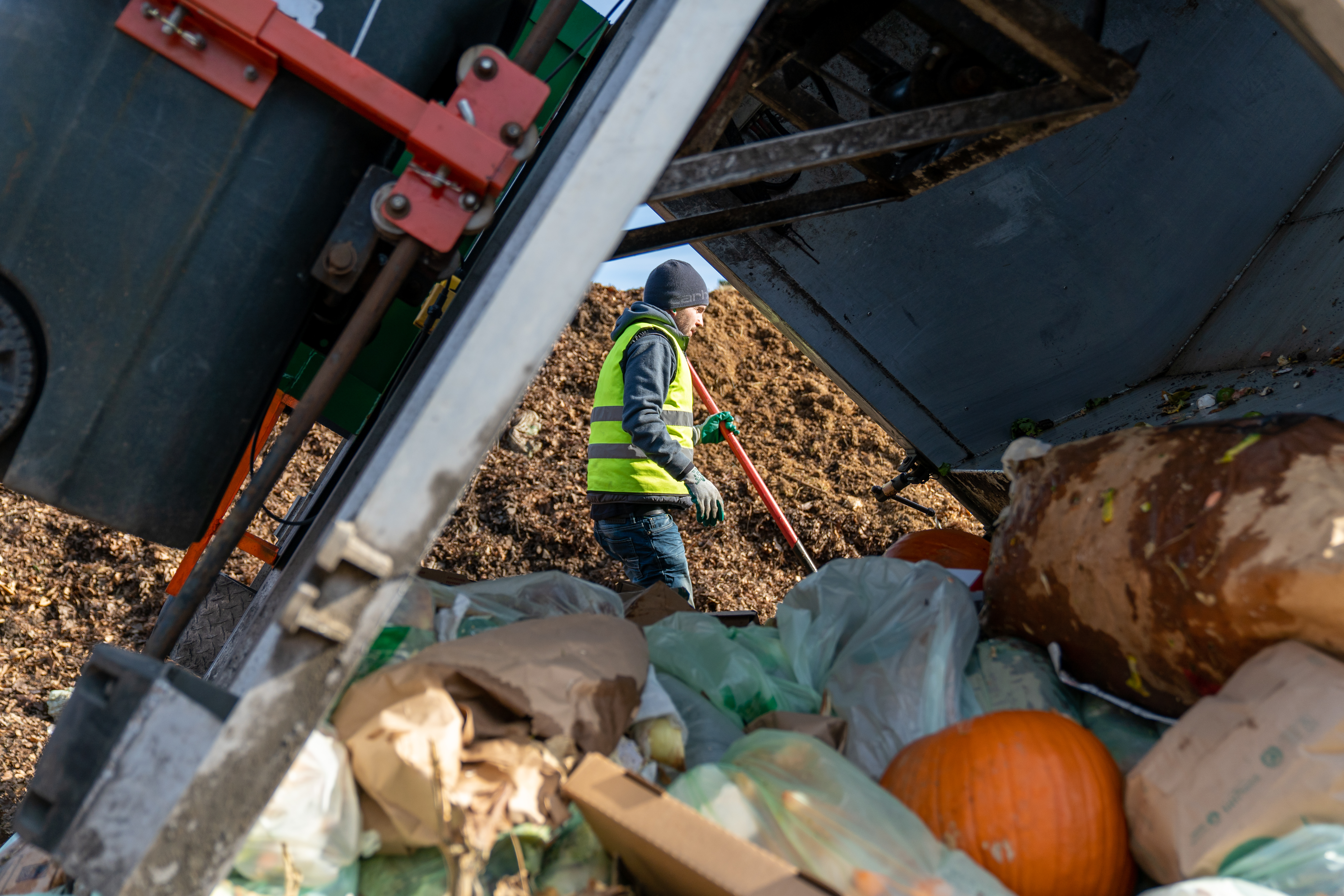 Composter looking at trash pile