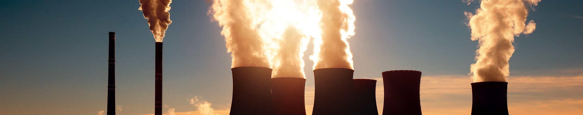 photo of coal powered plant with smoke coming from smoke stacks