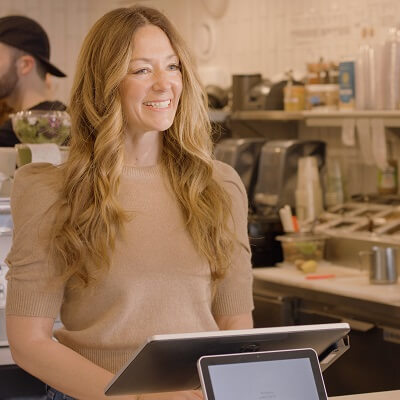 Jenn of laney and lu at register of her cafe