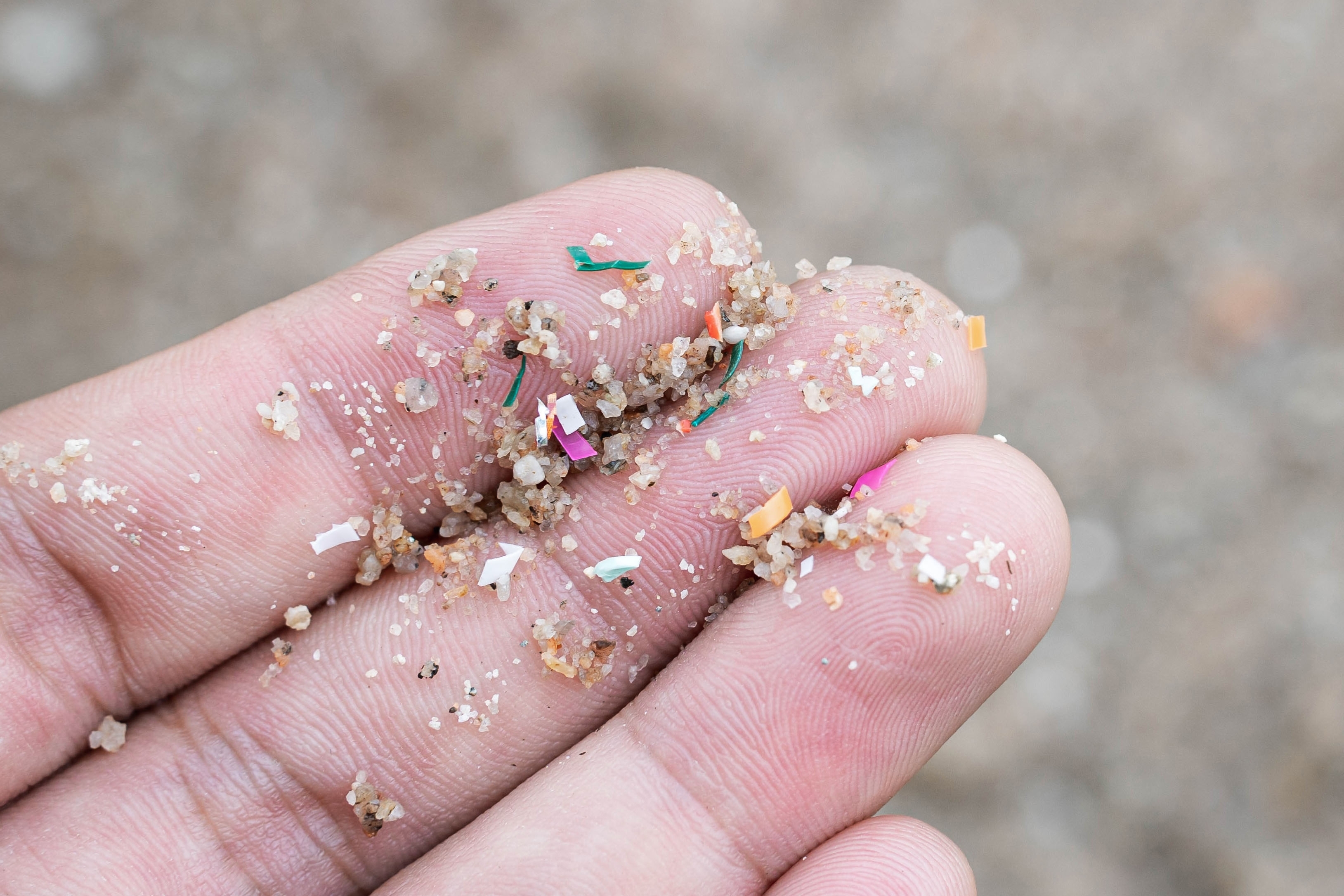 microplastics and sand in hand