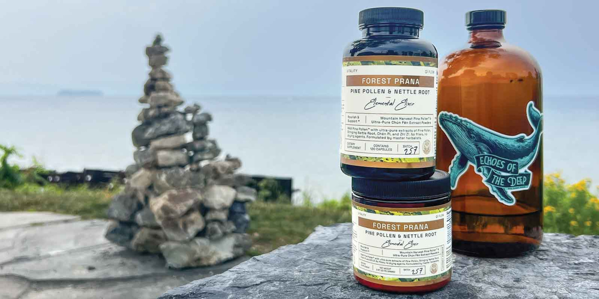 Forest Prana Pine Pollen and Nettle Root Elixir Capsules and Powder on lakefront stone.