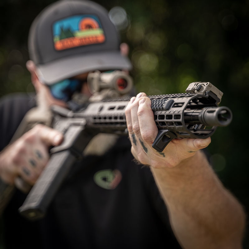 man holding AR-15 with VZ Grips Rail Covers and handstop