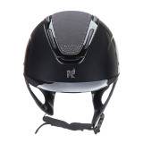 Karben Amity blends top-tier performance and safety with striking personality and style, giving every rider the perfect balance of confidence and comfort. A high gloss frame and peak meet a gloss sculpted shell, accented by the centred Karben insignia – the hallmark of modern safety. SPKL features tonal diamante detail at the crown, perfectly set off by the matt microfibre crown and followed through in the insignia for extra glitz. The AIR-XC System of six outer and ten inner vents work, promote air exchange, removing warm moist air and drawing in fresh air to keep the head comfortable through any ride. Karben hats are thoroughly tested to the latest certifications for horse riding and feature carefully thought through safety and comfort measures to benefit the rider. Finer detail: BESPOKE FIT Micro Adjustable Dial System. PASSIVE AIR-XC SYSTEM channels heat release and ventilation. SHOCK ABSORBING expanded polystyrene inner shell engineered with 10 targeted ventilation shafts. Flexible fixed peak for impact energy absorption. Deeply padded COMFORT LUXE LINER with CoolDryTM headband and THERMOREGULATING 3D mesh crown. Fully adjustable 4-point harness in stretch resistant web with embossed soft faux leather wrapped sides. Quick release buckle. Removable anti-rub chin guard. Machine washable linings. Reusable drawstring storage bag. Amity hats meet the safety requirements of PAS015:2011 and BS EN 1384:2023 with the CE mark and BSI Kitemark.