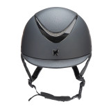 Fine tune your fit with dial adjusted Karben Ellipse riding hats. Exquisite Emory features a mock leather crown to pair with the textured detail of the matching peak. The low sheen look is enhanced by the high shine gun metal grey frame and a matt outer shell. SP Ellipse hats feature a distinctive mock leather wrapped peak with the Karben monogram set above to gracefully set off the look. The flattering low profile sits deep on the head with carefully engineered geometry for harmony. Karben hats are thoroughly tested to the latest certifications for horse riding and feature carefully thought through safety and comfort measures to benefit the rider. FINER DETAIL: BESPOKE FIT Micro Adjustable Dial System. PASSIVE VENTILATION SYSTEM air channels vent towards the head. SHOCK ABSORBING expanded polystyrene inner shell engineered with targeted ventilation shafts. Flexible fixed peak for impact energy absorption. Scratch resistant carbon wrapped rim. Deeply padded COMFORT LUXE LINER with CoolDryTM headband and THERMOREGULATING 3D mesh crown. Fully adjustable 4-point harness in stretch resistant web with embossed soft faux leather wrapped sides. Quick release buckle. Removable anti-rub chin guard. Machine washable linings. Reusable drawstring storage bag. Thoroughly tested and certified to PAS 015:2011 and EN 1384:2023. CE & BSI Kitemark.