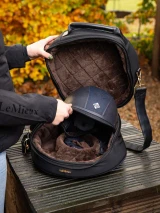 This luxurious hat box is perfect for storage at the yard or travelling to clinics and shows. The super soft quilted faux fur lining keeps your hat clean and protected.

Designed for elegance and practicality, there's a detachable shoulder strap and comfortable rolled faux leather handle.

An internal air-vented compartment stores your gloves, with an additional pocket for hair nets and accessories. The large double zip clam shell opening offers easy access.

The Luxe Hat Box coordinates with the Luxe Luggage range, ideal for competitive riders.