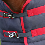 A smart lighter weight stable rug with 100g fill, perfect for when a lighter rug is needed or to use as a layer. Made from a 300 denier material with quilted detailing to keep your horse snug. Featuring red cross surcingle’s, twin clip chest fastenings and fillet string to keep the rug securely in place. With generous tail flap for extra protection and finished with HyCONIC badge logo.