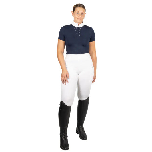 Designed to deliver performance without compromising on elegance, the Hy Equestrian Roka Reign Show Shirt is a must-have for any rider’s competition wardrobe. Crafted from breathable, lightweight fabric with four-way stretch, this shirt offers a close, flattering fit while allowing complete freedom of movement in the saddle. The moisture-wicking, quick-dry material keeps you cool and comfortable under pressure, making it ideal for long show days. Featuring a smart, crisp collar and subtle diamante design accents, the Roka Reign Show Shirt blends classic show-ring style with modern functionality. Whether you're competing in dressage, jumping, or eventing, this shirt combines performance-focused features with timeless design to help you look and feel your best in the ring.