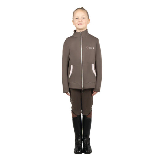 This smart jacket offers the ultimate in flexibility and comfort as the soft fabric is lightweight and quick drying, featuring diamante, stitched and silicone emblems to the chest. A two-way zip is easily adjusted in the saddle or on the yard and two front pockets provide useful storage. This smart jacket with hood will protect your little one from the elements thanks to the windproof and showerproof outer. Part of the Lucky Pony collection.