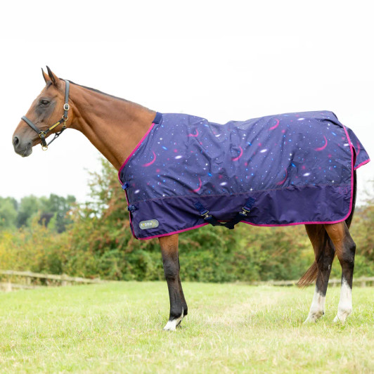 Take your horse’s comfort to a whole new galaxy with the StormX Original Out of this World 100 Turnout Rug. Designed with a bold, space-themed print, this midweight rug is as fun as it is functional, offering excellent protection during those unpredictable weather days. Made from a durable, waterproof 600 denier ripstop outer, it’s tough enough to handle daily wear while still allowing breathability for your horse’s comfort. The 100g fill provides just the right amount of warmth for cooler days, making it ideal for the transitional seasons or clipped horses that need a little extra insulation. Featuring secure twin buckle chest fastenings, adjustable cross surcingles, leg straps, and a generous tail flap, this rug ensures a snug, protective fit to keep your horse cosy and dry.