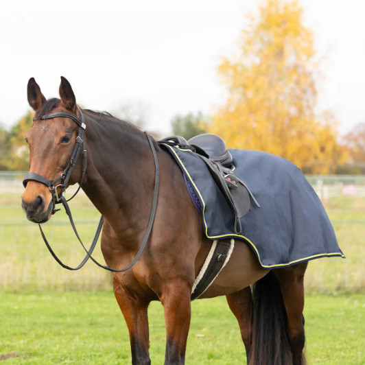 Don’t be a fair-weather rider with the StormX Original Waterproof Exercise Sheet. It is made from a waterproof, yet breathable, rip-stop outer material and benefits from a warm fleece lining so your horse will stay warm and dry in any weather. Featuring a touch tape front fastening, girth loops, and a fillet string it can be quickly put on or removed. It’s perfect for everyday use but also handy to have when you’re out at shows if the weather takes a turn for the worst. Reflective piping around the edge adds extra visibility when out hacking. Comes in Navy or Black.