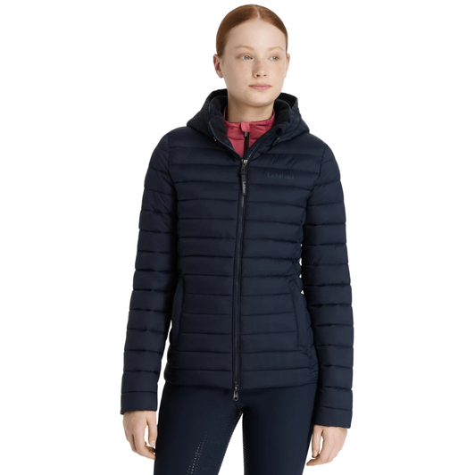 Do it all in this classic lightweight water-resistant puffer jacket. In a step towards sustainability, it's filled with recycled down quilting, which is light and warm with a lovely loft for lasting puffiness.

Be prepared for unpredictable, chilly days with this water-resistant jacket. Its detachable quilted hood provides versatility, allowing you to adapt to changing weather conditions. The luxurious metal finishings are a testament to the excellent quality you can expect from LeMieux.

The durable two-way front zip is great for riding and prevents scratches to your pommel. A flattering and stylish cut, zipped pockets and subtle LeMieux branding make this jacket every young rider's must-have for riding, around the yard and the school run.