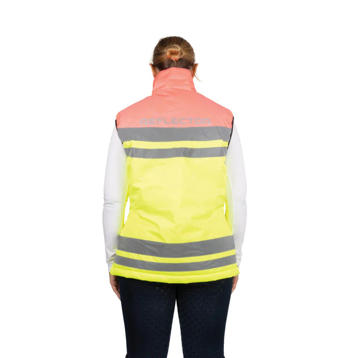 The Reflector Two Tone Gilet is a high-visibility outer layer designed for riders and outdoor enthusiasts who need safety, comfort, and protection in all weather conditions. The bold design combines different coloured fluorescent fabrics for standout visibility during both daylight and low-light hours. Reflective strips are strategically placed around the body and back to provide full 360-degree visibility, ensuring the wearer can be seen from every angle. Made with a durable, waterproof outer, the gilet offers protection against rain and wind with light padding to ensure warmth without overheating. The tailored cut allows for ease of movement and a flattering fit, making it suitable for active use on horseback or on foot. The gilet includes practical features such as secure zipped pockets for carrying essentials and handy two-way zip to enhance comfort and fit.