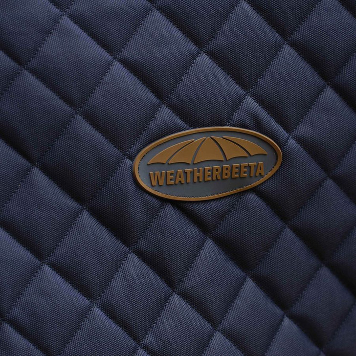The WeatherBeeta ComFiTec Deluxe Diamond Quilt Standard Neck Medium is a premium, quality deluxe stable rug with a durable PU coated 1200 denier diamond quilted outer and 250g of polyfill. Featuring a soft teddy fleece lining, fleece wither relief and cozi collar for additional comfort. This rug also features faux leather detail for a premium finish, twin quick clip adjustable front closure with touch tape for maximum adjustability and low cross surcingles with tail cord.