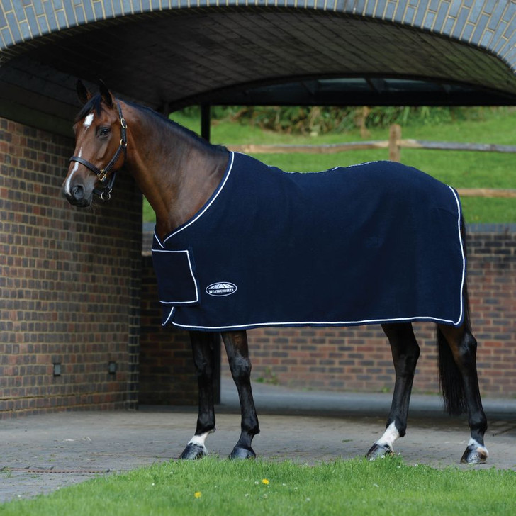 Stylish and warm wool show rug, ideal for travelling and keeping your horse clean. The WeatherBeeta Wool Show Sheet With Chest Panel Standard Neck is ideal for competitions, offering an 80% wool blend for natural breathability and comfort. Featuring a twin surcingle front closure with a chest panel cover for extra protection and a stylish look, plus tail cord. It provides a great option to add embroidery onto the side and chest panel for a unique touch.