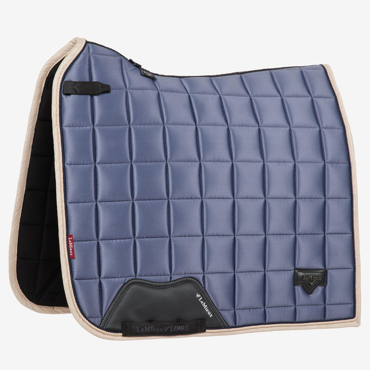 Described as the most stylish dressage pad LeMieux have ever produced. The Loire collection exudes sophistication and class - showing style without showing off! Woven Satin fabric gives a beautiful sheen to these pads whilst still benefitting from the wonderfully soft and breathable Bamboo lining. The 100% natural Bamboo material controls heat & sweat and wicks very efficiently.

The whole pad benefits from a new extensively researched soft friction-free suede binding which is specially fabricated to smoothly contour the edges. This new technique helps retain the perfect saddle pad shape and binding profile.

The textured PU leather girth protection area is complimented by an embossed logo and carries the usual signature LeMieux lower girth strap with its inner locking loops. The piece de resistance of the Loire Dressage Square is its unique metal badge on a leather mount in the lower back corner.