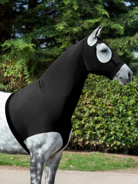 Your show day essential, this four-way stretch hood is technically crafted for the closest possible fit. Ideal as a dirt barrier on a newly groomed, bathed, or plaited horse, it protects the head and shoulders while allowing free movement.
With this kind of hood, exact fit is important, to keep movement on the horse to a minimum and eliminate rubbing. Thoughtfully designed with fit in mind, the hood’s fixings are minimal yet sturdy. A covered YKK zip, ending in an anti-lint hook and loop tape tab, firmly secures the neck from chest to chin. Meanwhile, loops on the panel between the front legs and an adjustable belly strap with durable clip closure give you options for precise fitting to your horse’s chest depth.
Generously cut eye holes will not rise when eating at low level, and a fully elasticated nose with LeMieux logo to the front delivers a neat fit on the face.