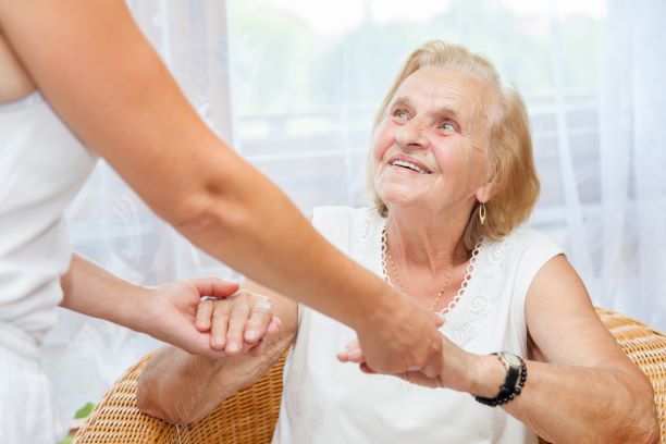 elderly woman being helped up