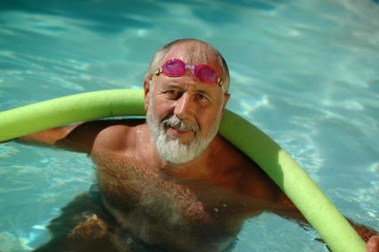 elderly man swimming in pool