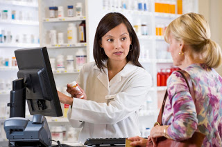 pharmacist talking to elderly woman