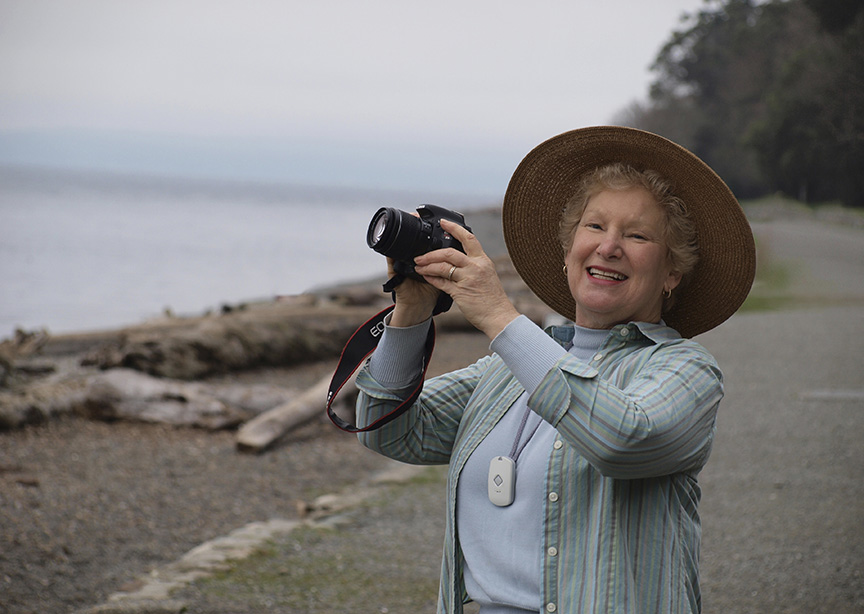 cellular medical alert worn by woman with camera on beach