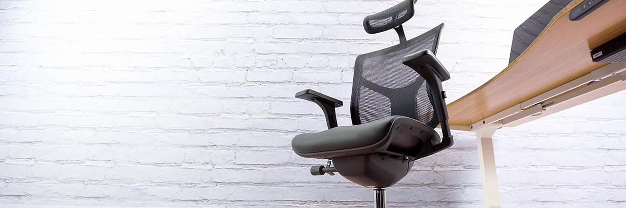 An ergonomic chair at a stand up desk