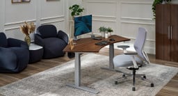 Home office setting featuring UPLIFT Desk furniture. Focal point is a 120-Degree standing desk with accessories and seating