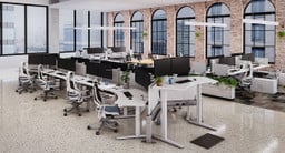 Modern office space outfitted with UPLIFT Desk products, featuring the 120-Degree Standing Desks, perfect for team offices