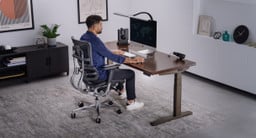 UPLIFT V3 Standing Desk with a Dark Rubberwood desktop and an Intuition Ergonomic Chair