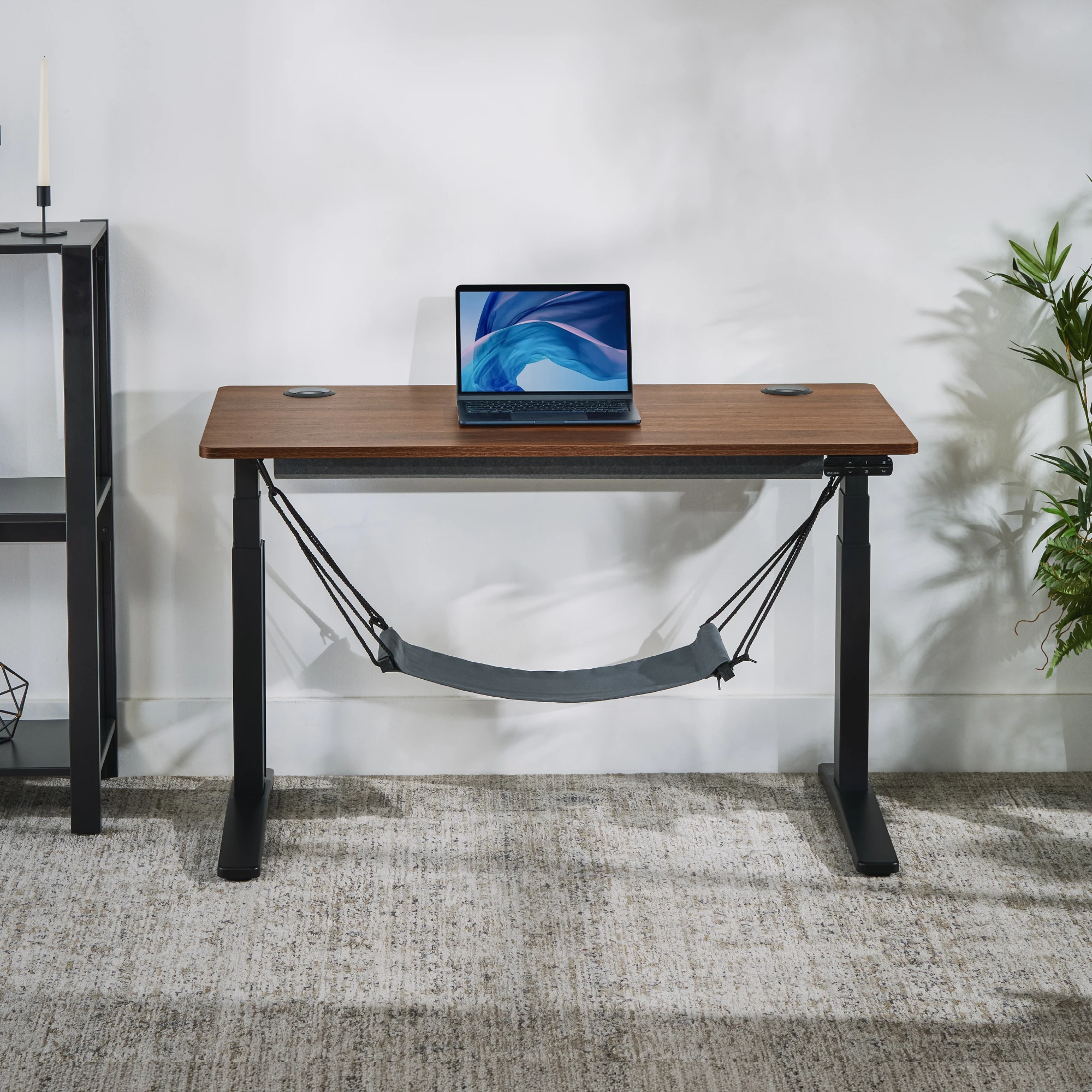 The Foot Hammock attached to the accessory mounting system on an UPLIFT V3 Essential Standing Desk